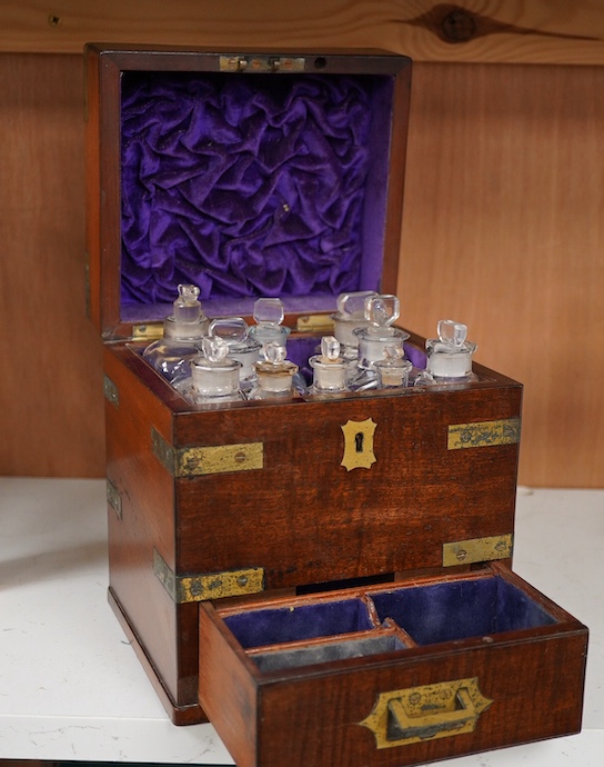 An early 19th century mahogany apothecary box, containing ten glass bottles, one with original paper label for the chemist Elam, 196 Oxford Street, London, with draw beneath containing a pair of scales, and weights, etc.